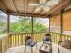 Inviting screened porch with ceiling fan and wood floors, perfect for relaxing outdoors at 106 E Cedar St, Tarpon Springs, FL 34689