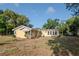 Backyard view of the home showcasing a sunroom and a spacious lawn area at 108 E Morgan St, Brandon, FL 33510