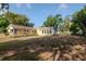 View of the house from the backyard, featuring a sunroom and mature trees and landscaping at 108 E Morgan St, Brandon, FL 33510
