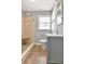 Bathroom featuring a tiled shower with built-in seat, modern vanity, window, and tile flooring at 108 E Morgan St, Brandon, FL 33510