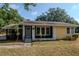 Exterior shot of the home's front with a porch area and yellow facade at 108 E Morgan St, Brandon, FL 33510