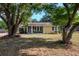 Charming single-story home featuring a welcoming front yard, mature trees, and a yellow exterior at 108 E Morgan St, Brandon, FL 33510