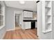 Kitchen and dining area with wood floors, white cabinets with black trim, and black appliances at 108 E Morgan St, Brandon, FL 33510