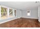 Bright living room featuring wood floors and multiple windows offering natural light at 108 E Morgan St, Brandon, FL 33510
