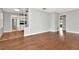 Bright living room has wood floors and an open floor plan into the kitchen at 108 E Morgan St, Brandon, FL 33510