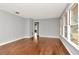Open living area with wood floors and paneled walls featuring natural light at 108 E Morgan St, Brandon, FL 33510