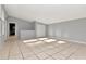 Bright living room featuring neutral walls, tile flooring, and natural light from the windows at 108 E Morgan St, Brandon, FL 33510