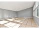 Bright living room featuring tiled floors, gray walls, and multiple windows at 108 E Morgan St, Brandon, FL 33510