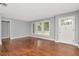 Bright living room boasts hardwood floors, neutral paint and large windows at 108 E Morgan St, Brandon, FL 33510