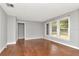 Sunlit living room features wood floors, neutral paint and updated windows at 108 E Morgan St, Brandon, FL 33510