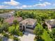 An aerial view of a beautiful home surrounded by lush greenery in a quiet neighborhood at 10837 Breaking Rocks Dr, Tampa, FL 33647