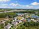 Aerial view of the home with a spacious backyard with lush surrounding landscape and ponds at 10837 Breaking Rocks Dr, Tampa, FL 33647