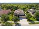 An aerial view of a beautiful home surrounded by lush greenery in a quiet neighborhood at 10837 Breaking Rocks Dr, Tampa, FL 33647