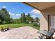 Brick paved patio with a view of the lush backyard and mature landscaping at 10837 Breaking Rocks Dr, Tampa, FL 33647