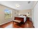 Comfortable bedroom features a window view, wood floors, and ample closet space at 10837 Breaking Rocks Dr, Tampa, FL 33647