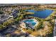 Aerial shot of community pool and amenity center next to a scenic pond at 10837 Breaking Rocks Dr, Tampa, FL 33647