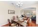 Formal dining room features a wood table with seating for six and elegant chandelier lighting at 10837 Breaking Rocks Dr, Tampa, FL 33647