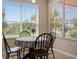 A charming dining area with large windows offering natural light and neighborhood views at 10837 Breaking Rocks Dr, Tampa, FL 33647