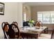 Dining room features a wood table with decor and seating, filled with lots of natural light at 10837 Breaking Rocks Dr, Tampa, FL 33647