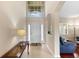 Bright entryway with a high ceiling, transom window, and tile flooring at 10837 Breaking Rocks Dr, Tampa, FL 33647