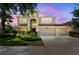 Charming two-story home featuring a manicured lawn, three-car garage, and covered entryway at 10837 Breaking Rocks Dr, Tampa, FL 33647