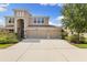 Stunning two-story home with a three-car garage and a well-manicured lawn at 10837 Breaking Rocks Dr, Tampa, FL 33647