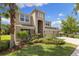 Beautiful two-story home with an arched entrance, three-car garage, and lush landscaping at 10837 Breaking Rocks Dr, Tampa, FL 33647