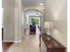 View of home hallway with tile floors and a glimpse of the living room beyond at 10837 Breaking Rocks Dr, Tampa, FL 33647