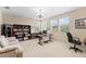 Spacious home office featuring large windows, a comfortable seating area, and ample desk space at 10837 Breaking Rocks Dr, Tampa, FL 33647
