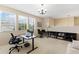 Bright home office with multiple workstations, large windows, and built-in shelving at 10837 Breaking Rocks Dr, Tampa, FL 33647