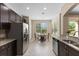Open kitchen with stainless steel appliances, granite countertops, and a dining area at 10837 Breaking Rocks Dr, Tampa, FL 33647