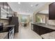 Open kitchen with dark wood cabinets, stainless appliances, and a breakfast nook at 10837 Breaking Rocks Dr, Tampa, FL 33647