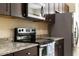 A well-equipped kitchen features stainless steel appliances and stylish granite countertops at 10837 Breaking Rocks Dr, Tampa, FL 33647