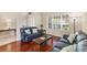 Cozy living room with a large window, natural light, and hardwood floors at 10837 Breaking Rocks Dr, Tampa, FL 33647