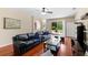 Open living room with hardwood floors and a sliding glass door to the patio at 10837 Breaking Rocks Dr, Tampa, FL 33647