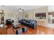 Spacious living room featuring hardwood floors, ceiling fan and furniture at 10837 Breaking Rocks Dr, Tampa, FL 33647
