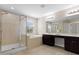 Luxurious main bathroom with dual vanities, a soaking tub, a tiled shower, and natural light at 10837 Breaking Rocks Dr, Tampa, FL 33647