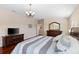 Spacious main bedroom with hardwood floors, television, access to en suite bath, and a view of sitting room at 10837 Breaking Rocks Dr, Tampa, FL 33647