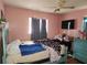 Cozy bedroom featuring a large bed, natural light, and a ceiling fan at 1100 Union S St, St Petersburg, FL 33712