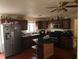 A fully equipped kitchen featuring dark wood cabinetry, stainless steel appliances, and a central island at 1100 Union S St, St Petersburg, FL 33712