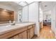 Bathroom with light wood vanity, spacious countertop, and a view to the bedroom at 1103 Old Mill Pond Rd, Palm Harbor, FL 34683