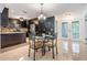 Eat-in kitchen area with dark wood cabinetry, granite countertops, modern appliances, and adjacent dining table at 1103 Old Mill Pond Rd, Palm Harbor, FL 34683