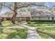 Charming single-story home with a well-manicured lawn, beautiful landscaping, and a peaceful, tree-lined setting at 1103 Old Mill Pond Rd, Palm Harbor, FL 34683