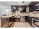 Well-equipped kitchen boasting granite countertops, a stainless steel sink, ample dark wood cabinetry, and tile flooring at 1103 Old Mill Pond Rd, Palm Harbor, FL 34683