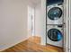 Convenient stacked washer and dryer unit in hallway, perfect for easy laundry access at 1103 Old Mill Pond Rd, Palm Harbor, FL 34683