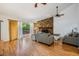 Cozy living room boasts stone fireplace and view of the outdoor deck through sliding glass doors at 1103 Old Mill Pond Rd, Palm Harbor, FL 34683