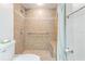 Tiled shower with a built-in bench and convenient grab bar, offering a safe and comfortable experience at 1103 Old Mill Pond Rd, Palm Harbor, FL 34683