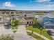 An aerial view of a home showing the lawn, landscaping, lake, and neighborhood at 11917 Greenchop Pl, Riverview, FL 33579