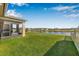 Beautiful backyard with waterfront view, green lawn, and screened-in patio at 11917 Greenchop Pl, Riverview, FL 33579