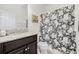 Bathroom features vanity with granite countertop, toilet, and shower with decorative curtain at 11917 Greenchop Pl, Riverview, FL 33579